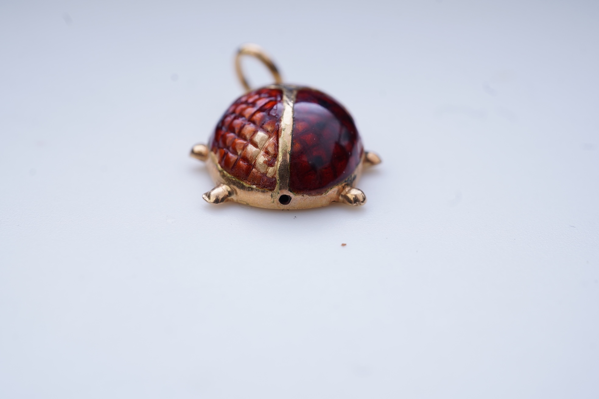 A gold and enamel pendant, Italy, 1960s